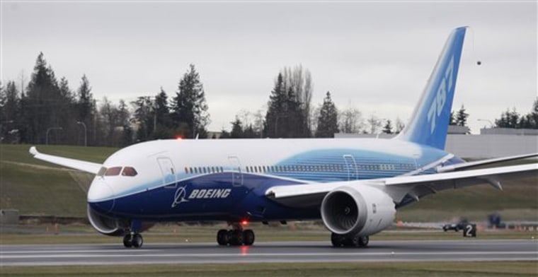 A Boeing 787 airplane taxis into position as a crowd of Boeing employees looks on. The slow global economic recovery and sharp cuts to national defense budgets are expected to blow a chill wind through the Farnborough International Airshow next week.